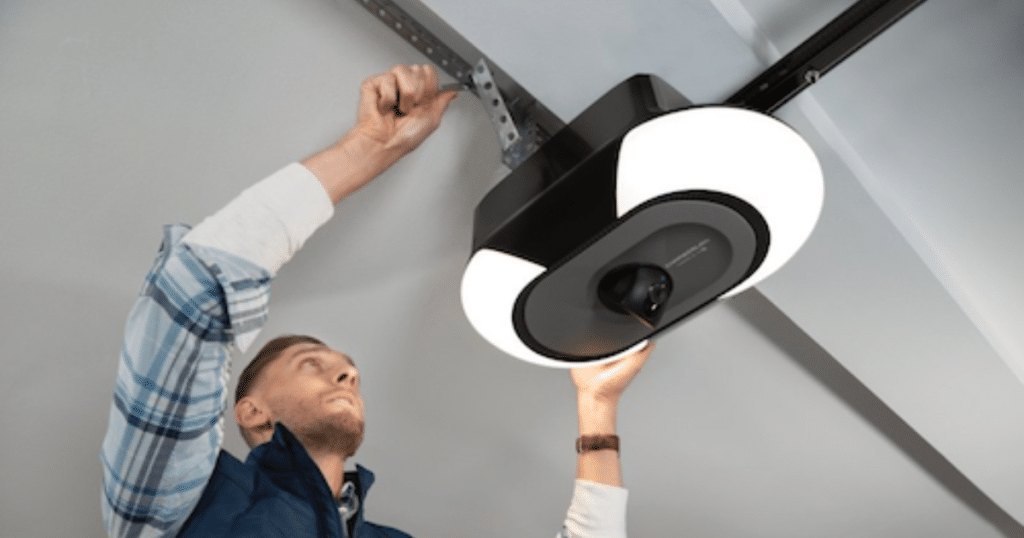 Man installs ceiling garage door opener.
