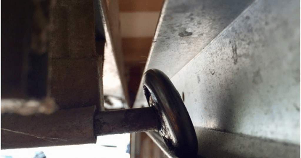 Close-up of garage door track and roller.